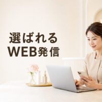 明るく上質なエステサロンで、パソコンとスマートフォンを使ってWEB発信を行う日本人女性スタッフと「選ばれるWEB発信」の文字を配置した画像